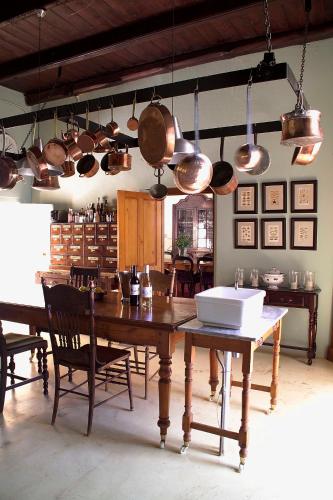 a kitchen with a table and pots and pans at Hawksmoor House in Stellenbosch