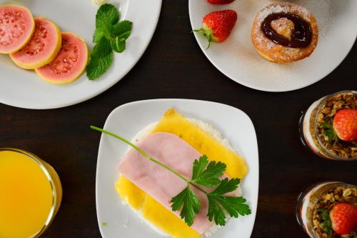 a table topped with plates of food and drinks at Rio Boutique Suites in Rio de Janeiro