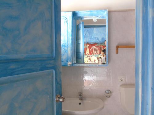 a bathroom with a sink and a mirror at Luxury Penthouse on the square with sea view in Sal Rei