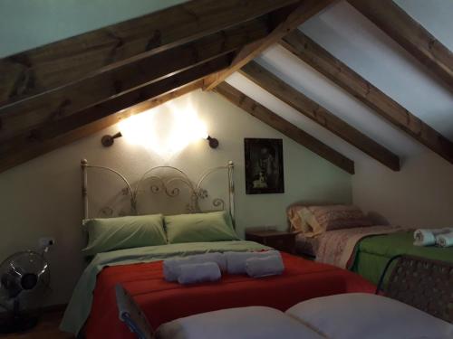 a bedroom with two beds in a attic at Quinta Santana in José de la Quintana