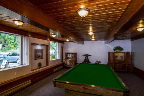 a room with a pool table in a house at Three Valley Lake Chateau in Revelstoke