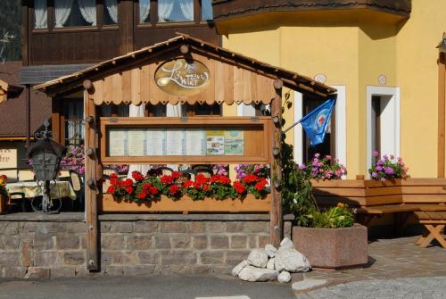 ein Blumenstand vor einem Gebäude mit Blumen in der Unterkunft Hotel Loewenwirt in Sexten