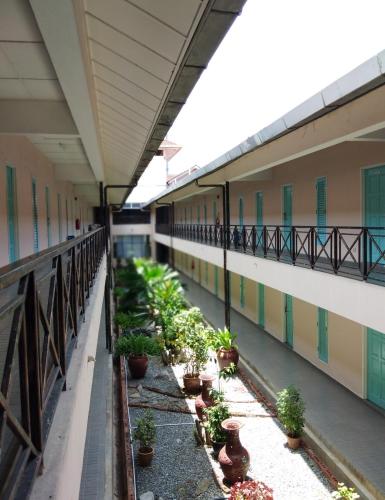 a balcony of a building with potted plants on it at Hotel Seri Malaysia Alor Setar in Alor Setar