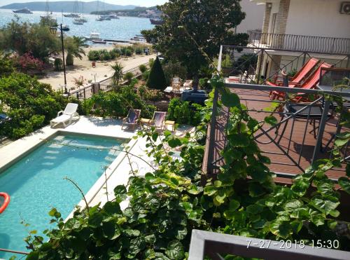 an apartment balcony with a swimming pool and plants at Apartments Gina in Trogir