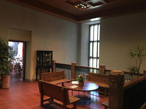 a room with a table and chairs and windows at MONASTERIO de SANTA MARÍA DE VALVANERA in Anguiano