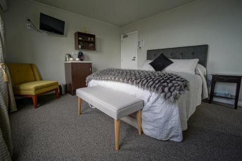 a bedroom with a bed and a chair at Lands End in Bluff