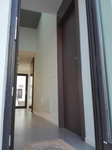 a hallway with a door leading into a room at Patio 101 "Exclusive" in San Vito lo Capo