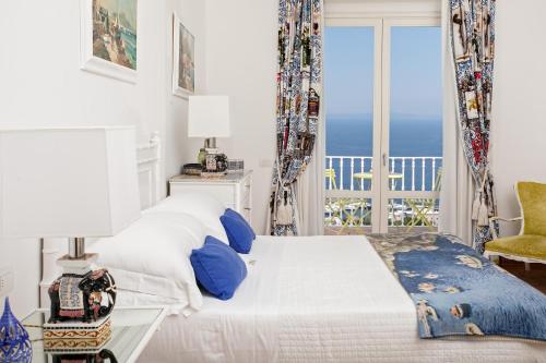 a bedroom with a bed with a view of the ocean at Casa Marta Capri in Capri