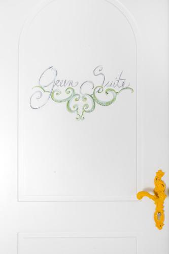 a sign that says excellence smile on a white wall at Casa Marta Capri in Capri