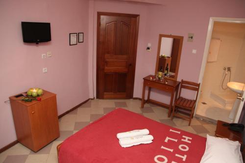 a hotel room with a bed and a table with towels at Ilios in Thessaloniki