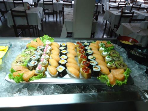 a variety of food items on a conveyor belt at Hotel Turista in Belo Horizonte