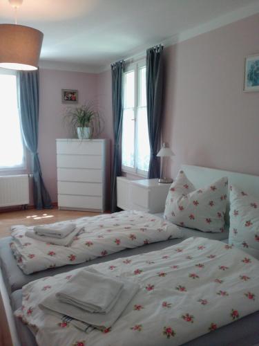 a bedroom with a bed with flowers on it at Gästehaus Villa Rose in Dürrröhrsdorf