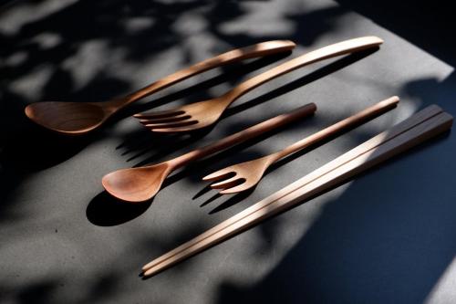 four forks and spoons on top of a table at 滔々 御崎 町家の宿 toutou Onzaki Machiya no Yado in Kurashiki