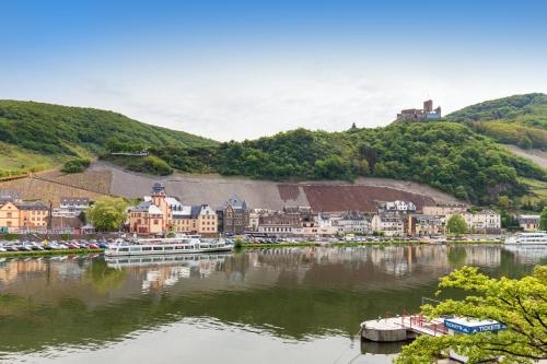 a town on a river with boats in the water at Moselhaus Weiskopf in Bernkastel-Kues