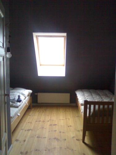 a bedroom with two beds and a window at Gutshaus Altbauhof in Dargun