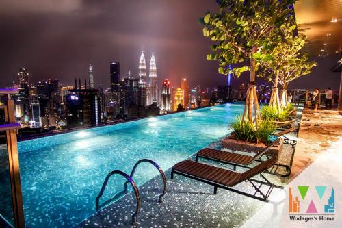 a swimming pool on top of a building with a city skyline at Expressionz KLCC by Wodages in Kuala Lumpur