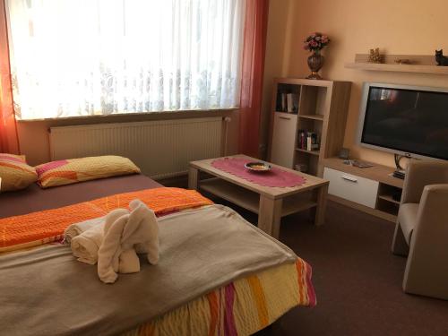 a hotel room with two beds and a television at Gästehaus Seestern in Cuxhaven