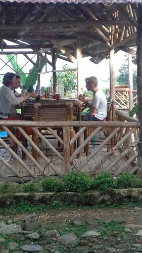 a group of men sitting at a wooden table at De Salak Homestay in Bogor