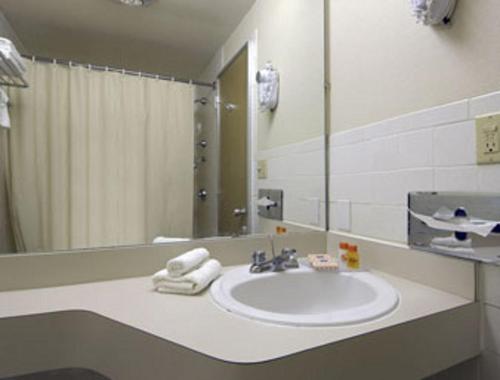 a bathroom with a sink and a mirror at Knights Inn Liberty in Liberty