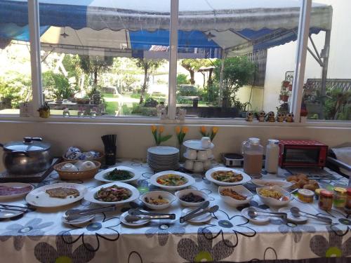 a table with bowls and plates of food on it at Niuniu & Meng Ka Homestay in Liugui