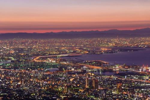 an aerial view of a city at night at T and K Hostel Kobe Sannomiya East in Kobe