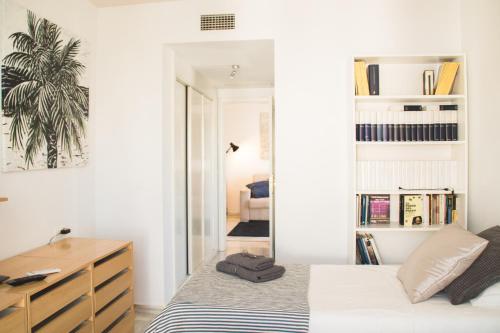 a bedroom with a bed and a desk and a mirror at Cozy Apartment Banus in Marbella