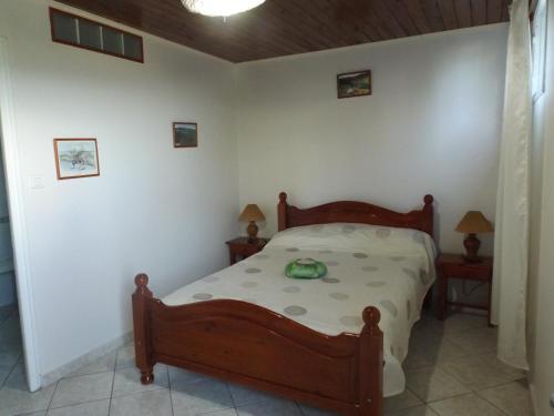 a bedroom with a bed and two night stands at Chambres Dhotes Nicole Maillot in Sainte-Marie