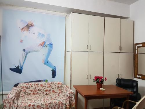 a room with a painting of a woman jumping at Sunny Apartment in Jerusalem