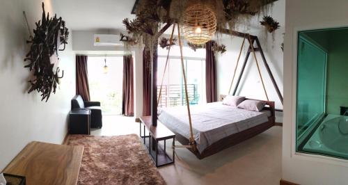 a bedroom with a canopy bed and a large window at Arbor's house and hostel in Chiang Mai