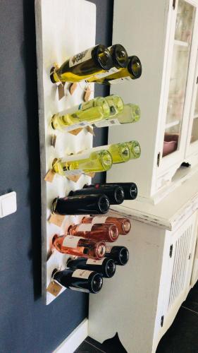 a bunch of wine bottles in a cabinet at Bed & Breakfast "aan de banis" in Rijssen