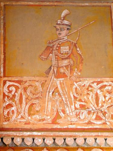 a painting of a soldier on a wall at Jaipur Haveli in Jaipur