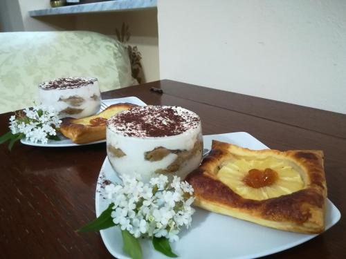 two plates of food on a table with desserts at LA CASA DEI MASUE' in Alba