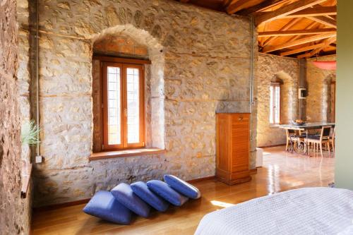 a bedroom with blue pillows on the floor at Cottage House in Traditional Greek Village in Kanália