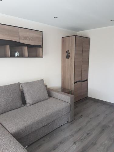 a living room with a couch and a cabinet at Boatman's harbor in Liepāja