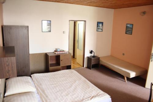 a bedroom with a bed and a bench in it at Bungalovy a ubytování Ratibořice- Zlíč in Česká Skalice