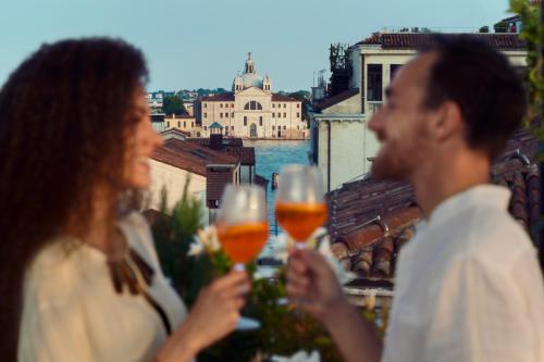 a group of people holding glasses of wine at Hotel Firenze in Venice