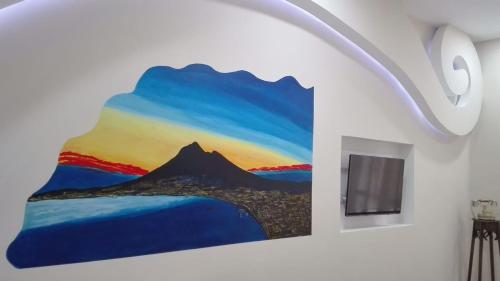 a painting of a mountain on a wall at Vesuvio Rooms in Gragnano