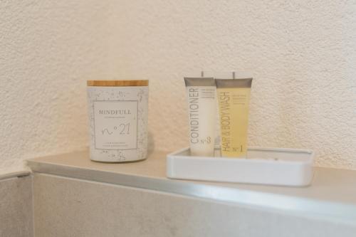 two products sitting on a shelf in a bathroom at Engine rooms in Rijeka