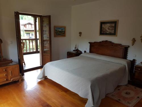 a bedroom with a bed and an open door at Casa Rural San Pelayo in Camaleño