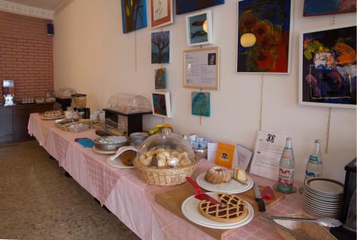 a table with food on it in a room at Piccolo Hotel Direkt am See in Brenzone sul Garda