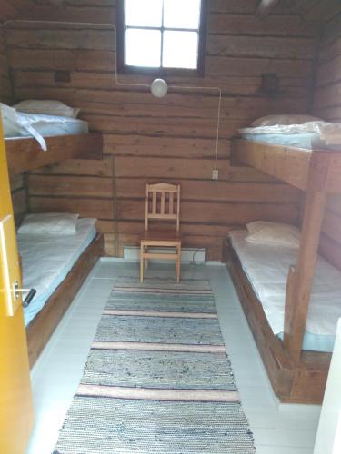 a room with two bunk beds and a chair at Suomela Camping in Kärsämäki