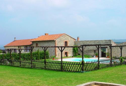 a house with a fence and a swimming pool at Chambres D'hotes De La Mure in Saint-Just-Saint-Rambert