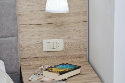 a table with books on it next to a lightswitch at Apartments Maritea in Vodice