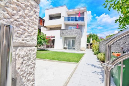a villa with a view of the garden at Apartments Maritea in Vodice