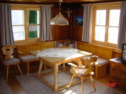 a dining room with a wooden table and chairs at Haus Sücka in Blons