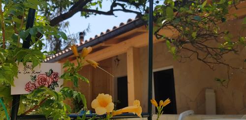 a mirror in front of a house with flowers at Le Tre Rose in Maratea