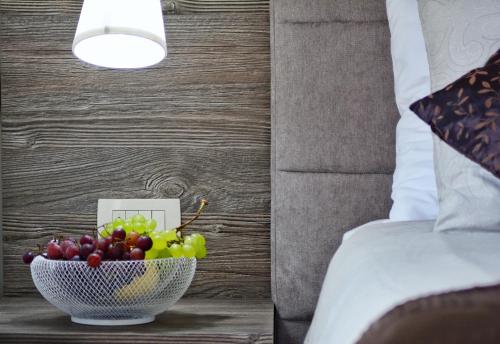 a bowl of fruit on a table next to a bed at Apartments Maritea in Vodice