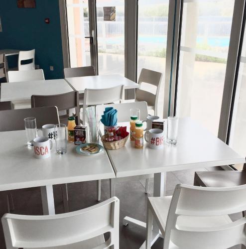une table et des chaises blanches avec de la nourriture dans l'établissement Maison Indigo 4 personnes, à Biscarrosse-Plage