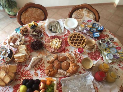 a table topped with lots of different types of food at B&B Il Corallo in La Maddalena
