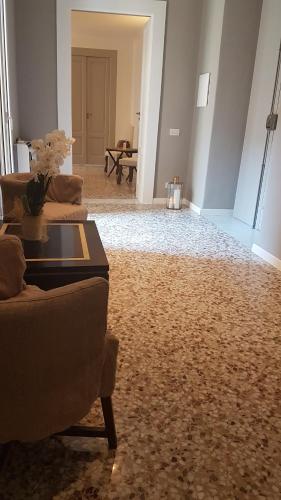 a living room with two couches and a table at MammaDada charm rooms in Bari